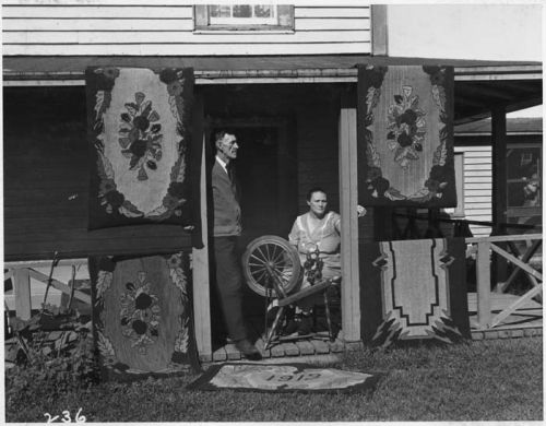 doorstep with spinning wheel and hooked rugs