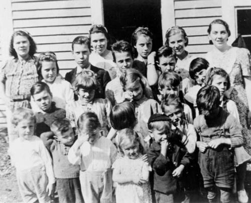 children with teacher at haystack
