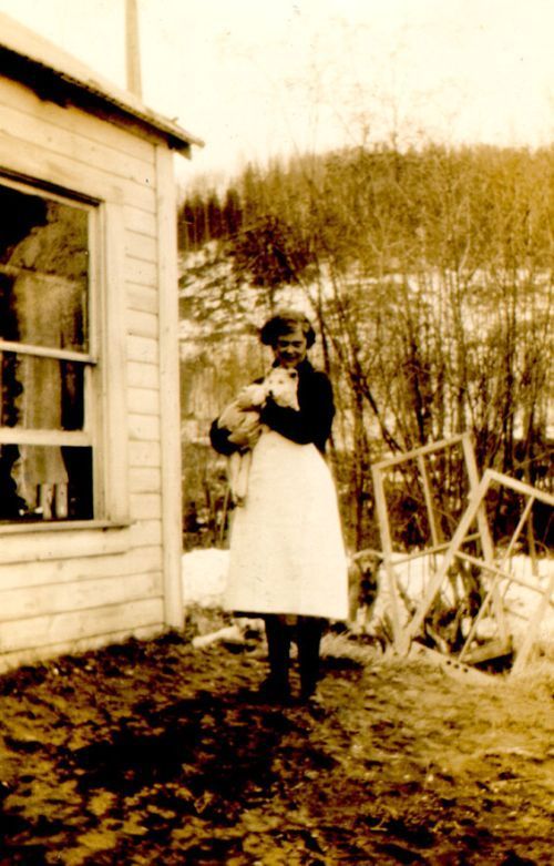 young woman holding a husky puppy