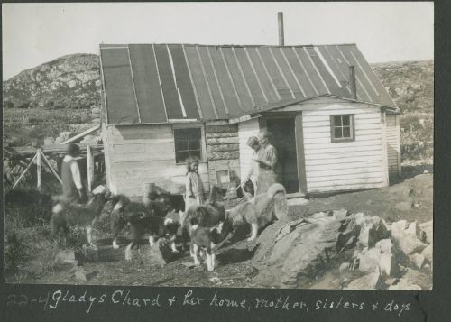 family outside home with dogs