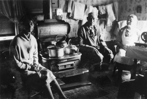 adults around kitchen stove