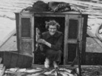 woman in boat with fish
