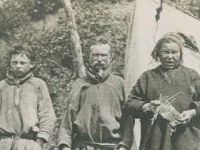 family standing by tent