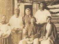 group standing by shack