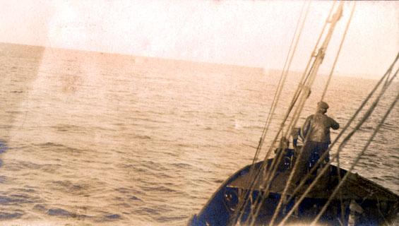 Man standing in the bow of a vessel hunting whales