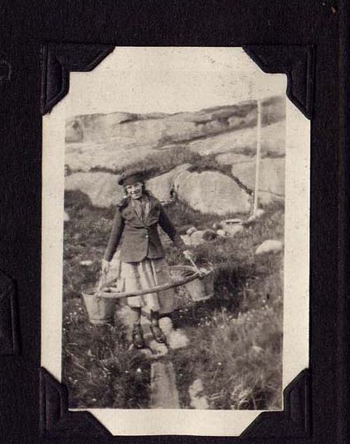 Girl carrying hoop and water buckets, Venison Tickle, Labrador, ca. 192-