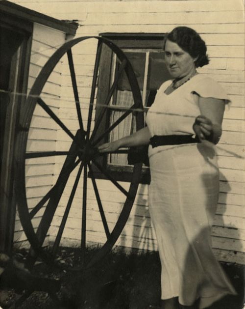 Alice Boland Spinning Outside House in Ferryland, 1938