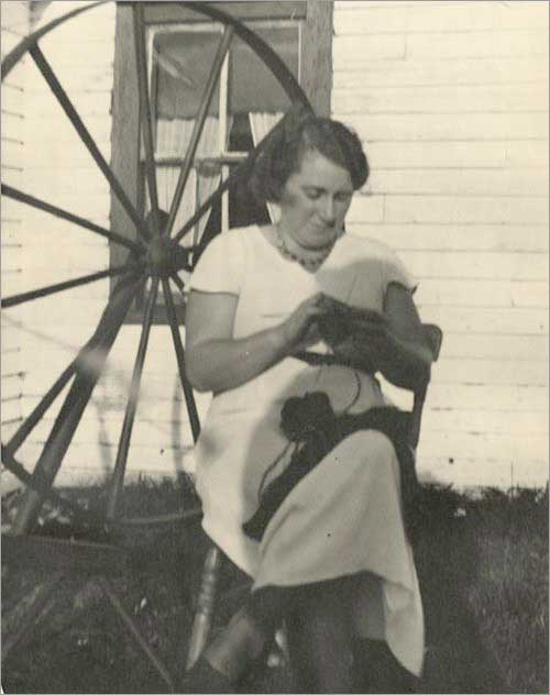 Alice Boland Knitting Outside House, Ferryland, 1938