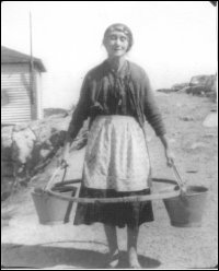 Mrs. Hannah Rogers carrying water at Fair Island