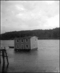 Leonard and Stella Hanlon House on the barge being moved from Bar Haven to Southern Harbour, Placentia Bay