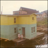 Jack Wadman house on a barge ready to move from Bar Haven to Southern Harbour, Placentia Bay