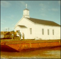 Anglican Church, Point Rosie, on the barge being moved to Frenchman's Cove, Fortune Bay
